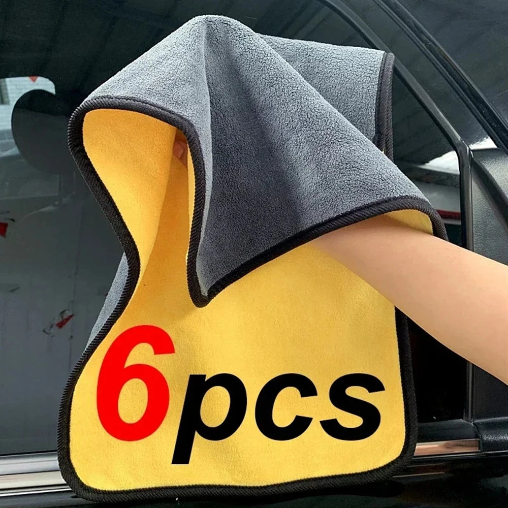 Hand holding a dual-color microfiber cleaning towel with “6 pcs” printed on it beside a car door